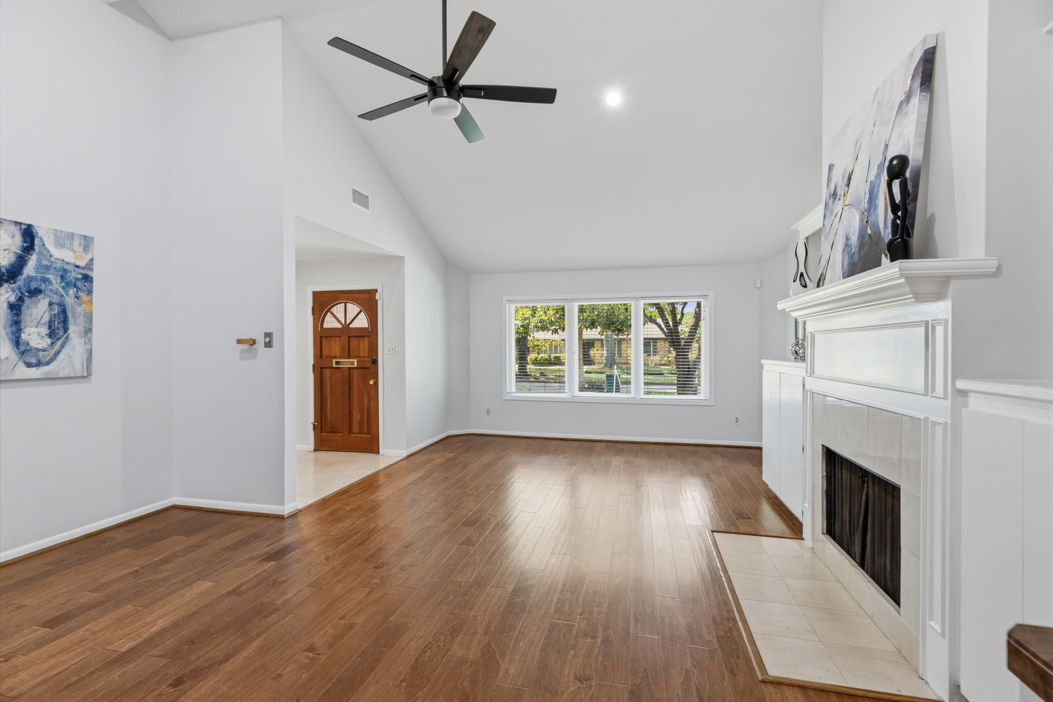 5410 Indigo Street Houston, TX 77096 - Photo 4 of 30 High ceilings right as you enter your home with great double pane windows for natural light and stately fireplace with gleaming floors in living area.