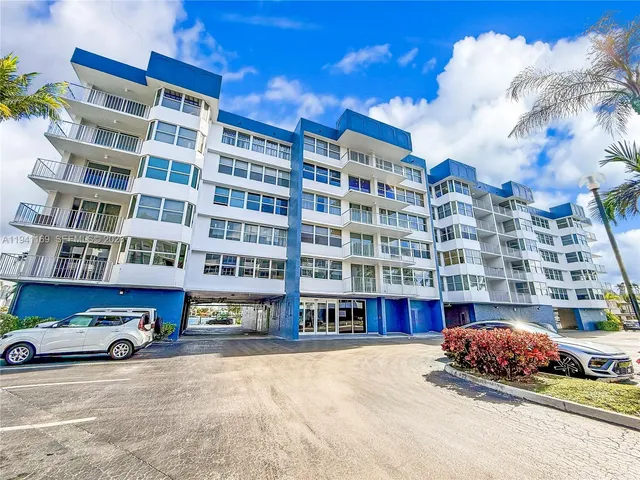a tall building with lots of trees in the background