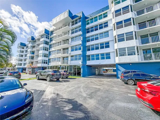 a buildings with car parked in front of it