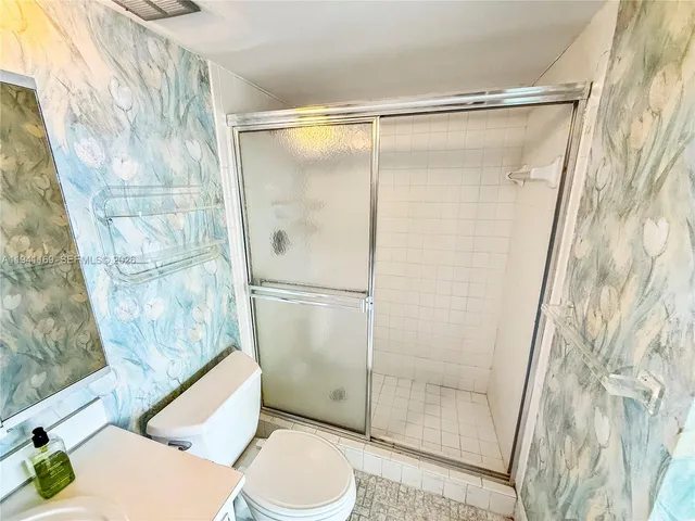 a bathroom with a shower and a toilet