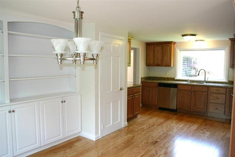 38 Leonard Road Hyannis, MA 02601 - Photo 11 of 35 a kitchen with stainless steel appliances a sink cabinets and wooden floor