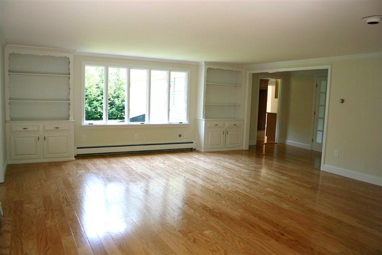 38 Leonard Road Hyannis, MA 02601 - Photo 4 of 35 an empty room with wooden floor and windows