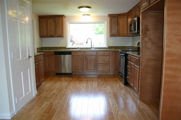 38 Leonard Road Hyannis, MA 02601 - Photo 10 of 35 a kitchen with kitchen island granite countertop a sink cabinets and stainless steel appliances
