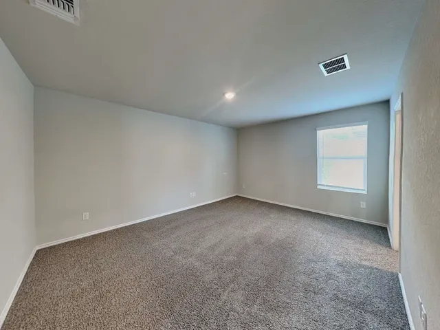 a view of an empty room and a window