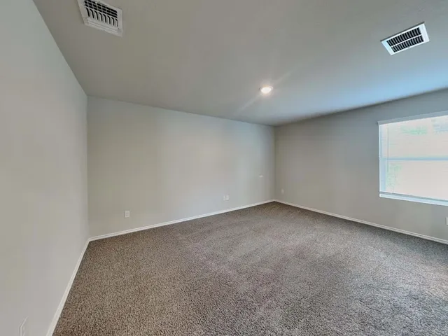 an empty room with a empty space and window