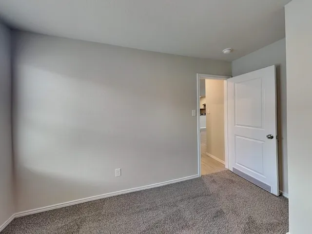 a view of an empty room and closet area