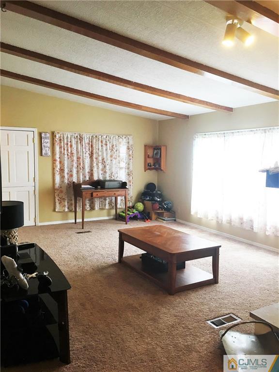6 Byron Road, Unit 6 North Brunswick, NJ 08902 - Photo 11 of 25 a living room with furniture and a large window