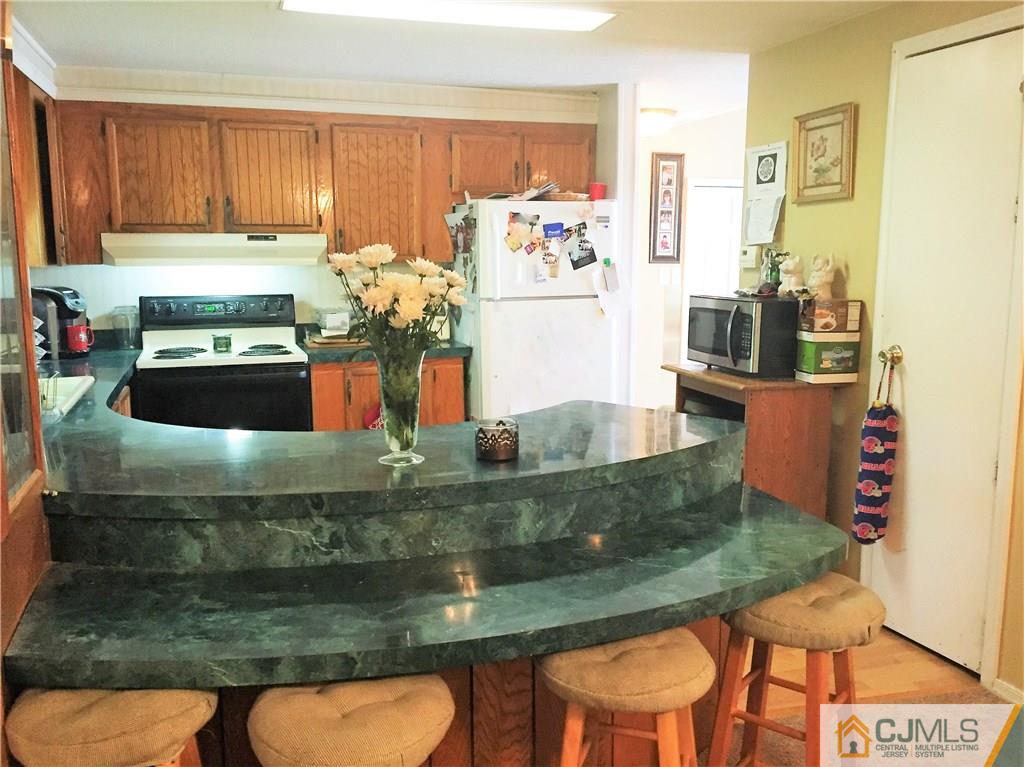 6 Byron Road, Unit 6 North Brunswick, NJ 08902 - Photo 15 of 25 a kitchen with kitchen island granite countertop a counter top space