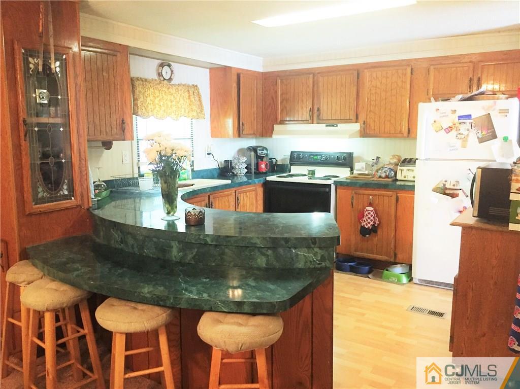 6 Byron Road, Unit 6 North Brunswick, NJ 08902 - Photo 16 of 25 a kitchen with granite countertop a sink and a stove