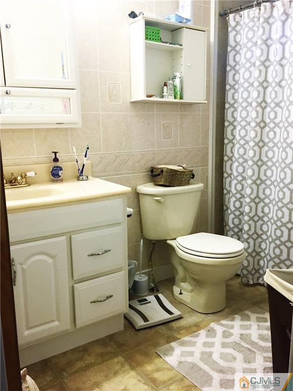 6 Byron Road, Unit 6 North Brunswick, NJ 08902 - Photo 20 of 25 a bathroom with a toilet sink and mirror