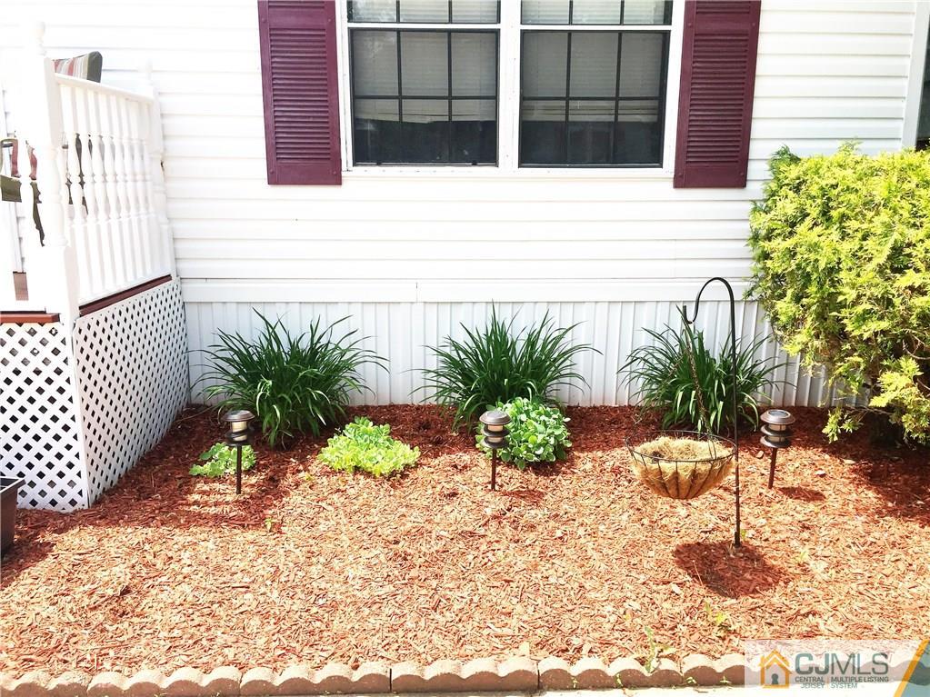 6 Byron Road, Unit 6 North Brunswick, NJ 08902 - Photo 25 of 25 a potted plant sitting on the side of a brick house