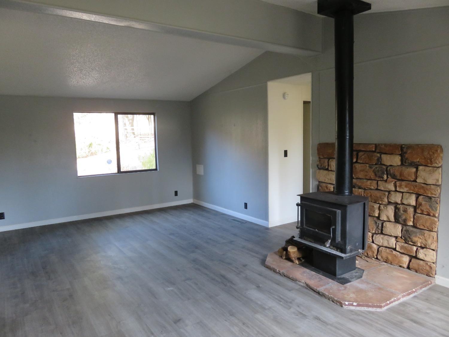 4426 Bald Mountain Road West Point, CA 95255 - Photo 34 of 45 a view of an empty room with wooden floor and a window