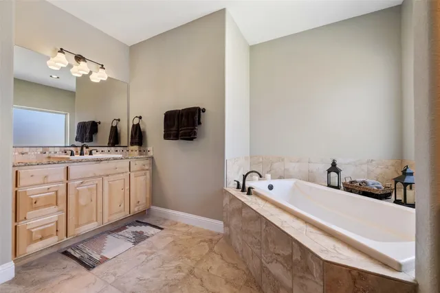 a large bathroom with a double vanity sink a mirror and a shower