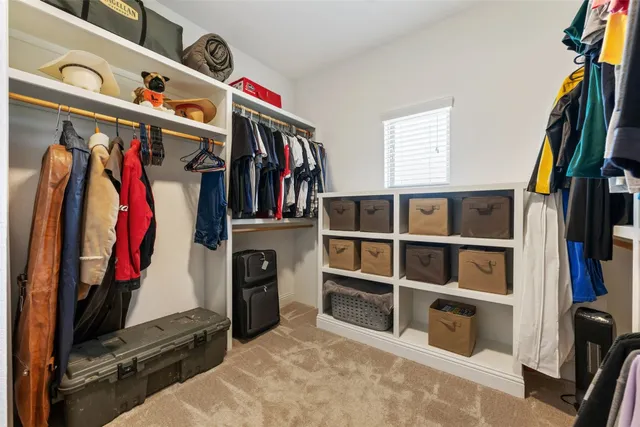 a bedroom with furniture and a large window