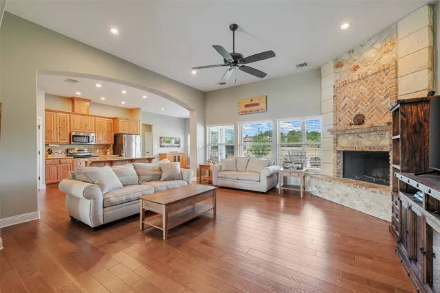 a living room with furniture a fireplace and a flat screen tv