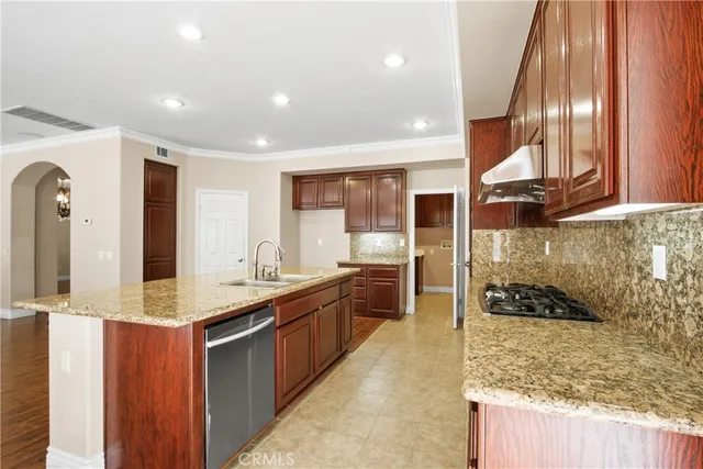 a large kitchen with stainless steel appliances double vanity and a granite counter tops