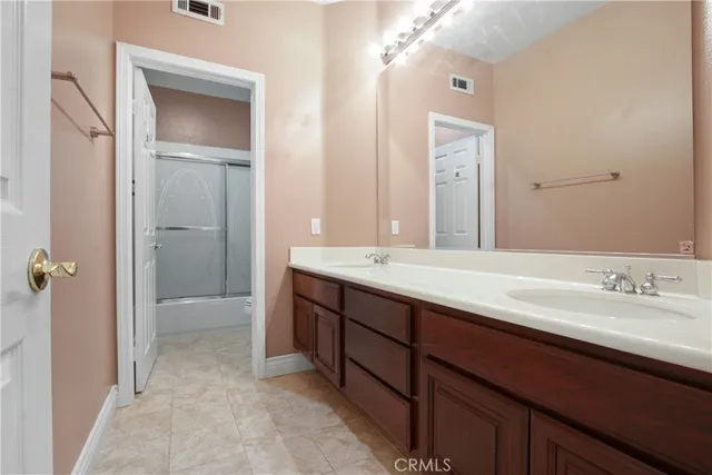 a bathroom with a double vanity sink and mirror