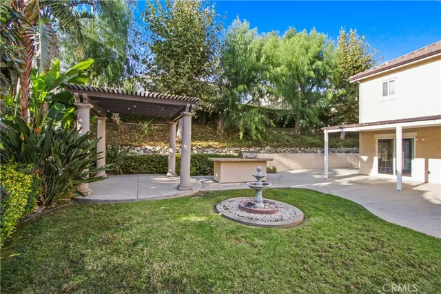 a view of a backyard with plants and a patio