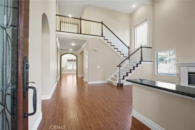 a view of entryway and hall with wooden floor