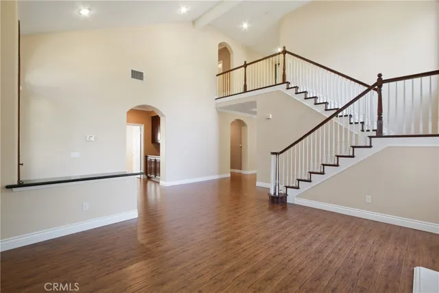 a view of staircase with wooden floor and white walls