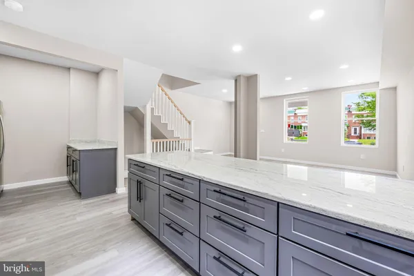 a spacious bathroom with a granite countertop sink and a large mirror