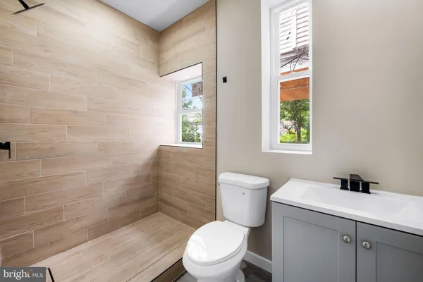 a white toilet sitting next to a bathroom sink