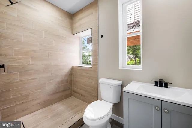a white toilet sitting next to a bathroom sink
