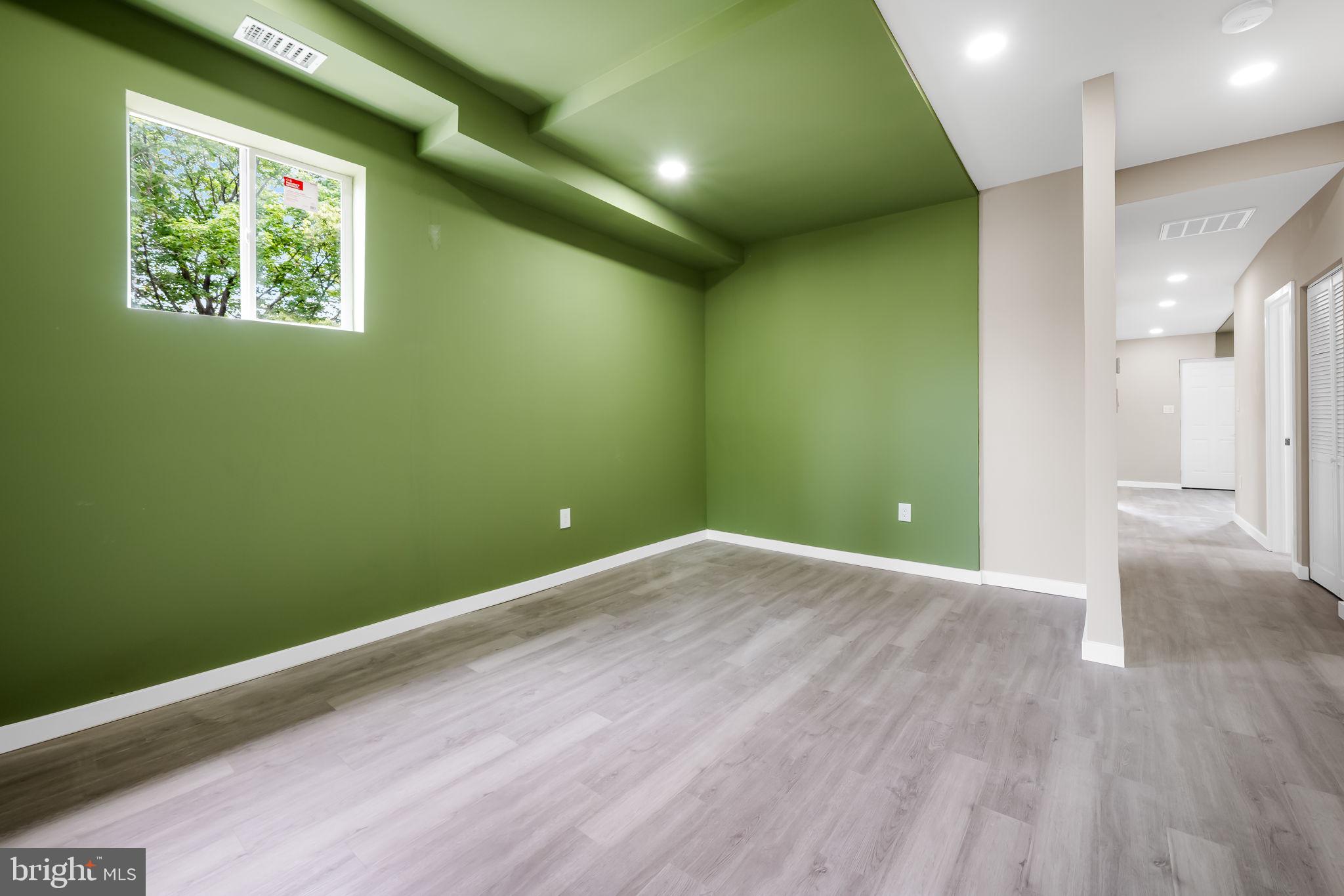 815 East 33rd Street Baltimore, MD 21218 - Photo 23 of 41 an empty room with wooden floor and windows