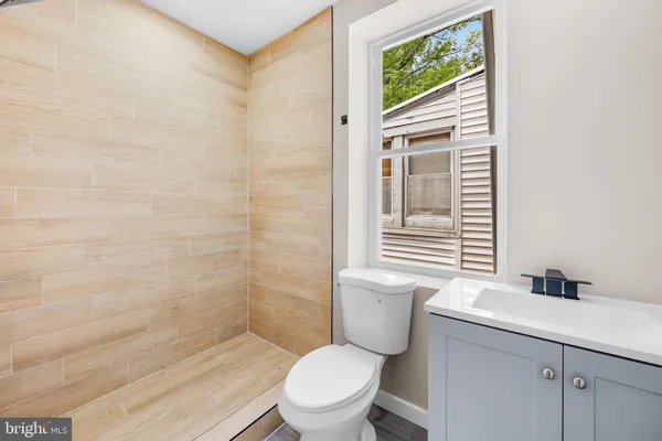 a bathroom with a toilet a sink and a window