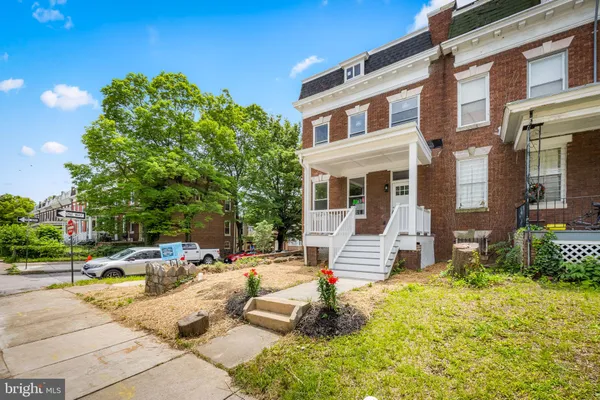 a front view of a building with outdoor seating