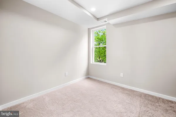 an empty room with window and a ceiling fan