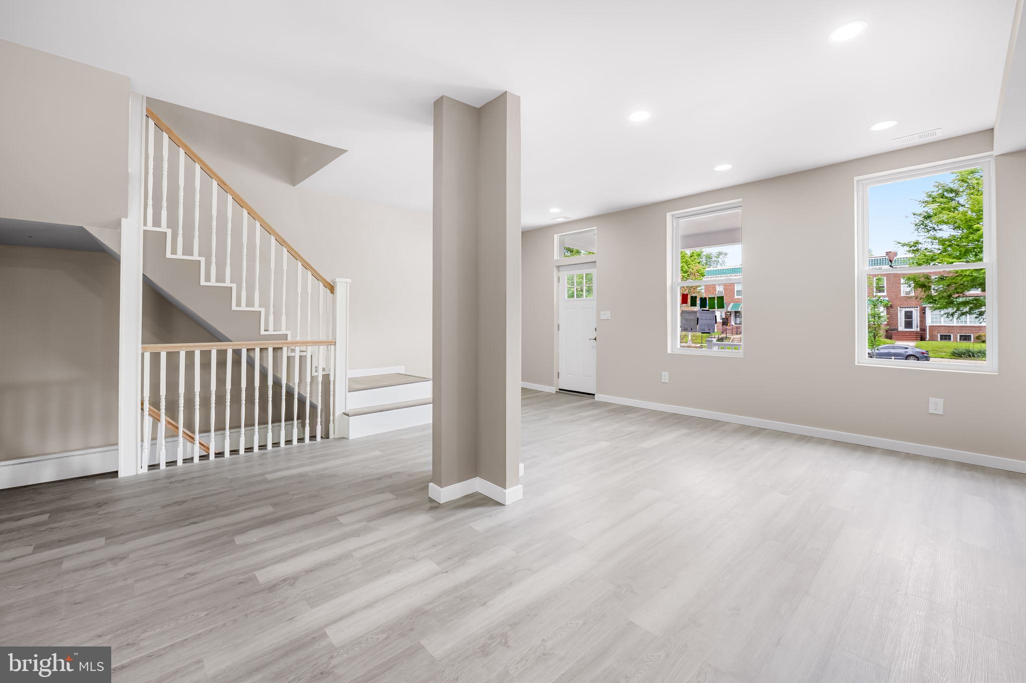 815 East 33rd Street Baltimore, MD 21218 - Photo 5 of 41 wooden floor in an empty room with a window