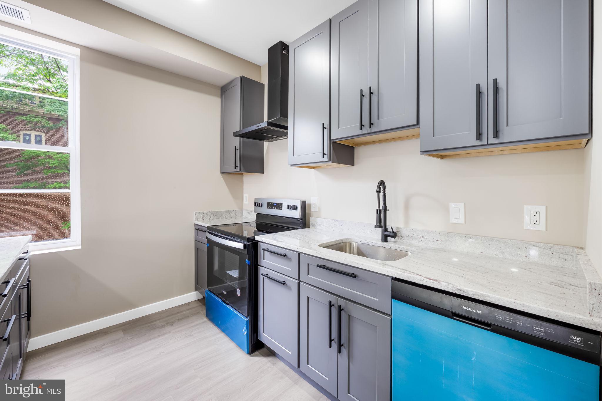 815 East 33rd Street Baltimore, MD 21218 - Photo 9 of 41 a kitchen with stainless steel appliances granite countertop a sink stove and cabinets