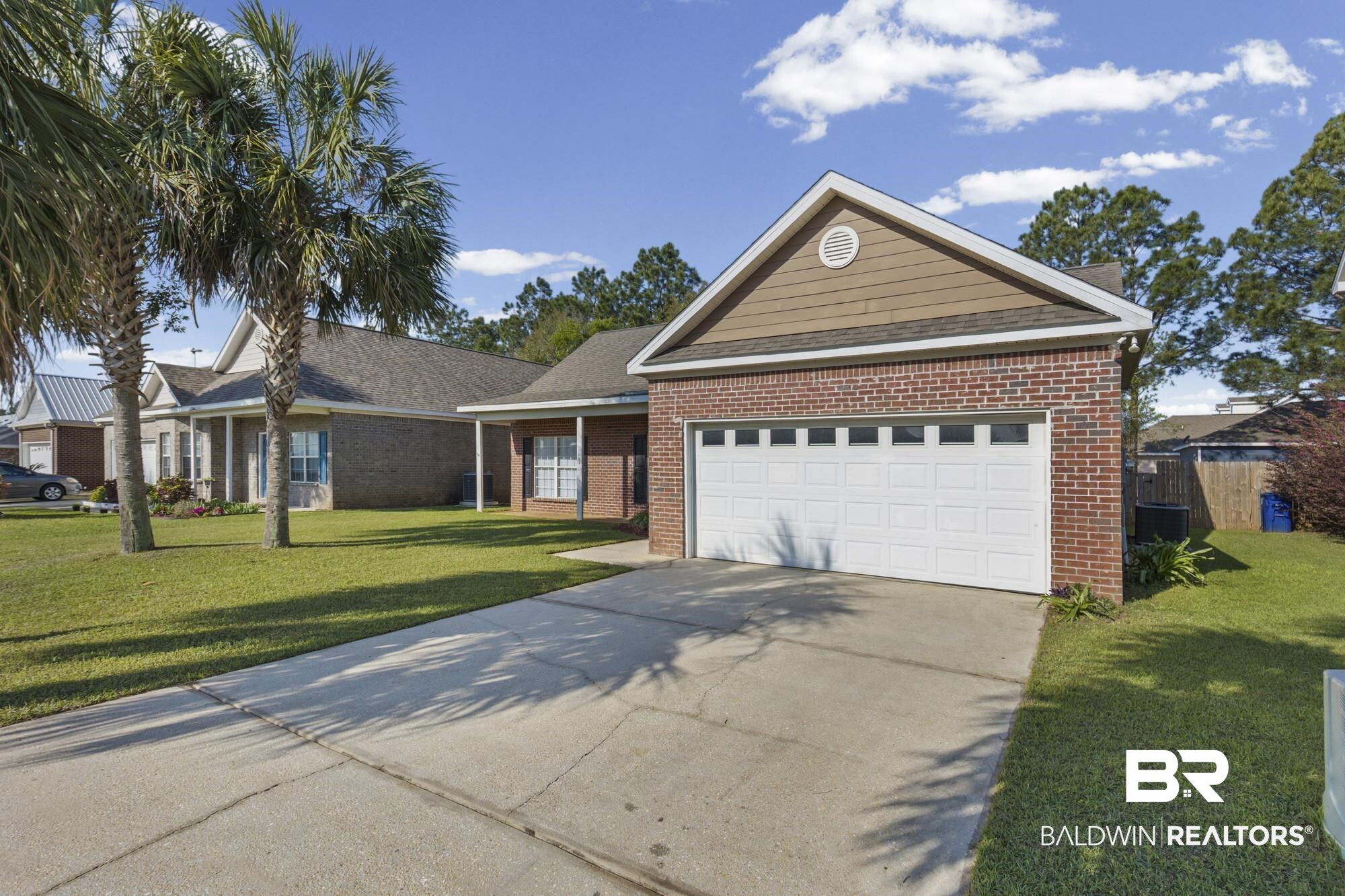 1153 Sloane Cove Foley, AL 36535 - Photo 2 of 25 Ranch-style house featuring driveway, a front yard, a garage, and brick siding