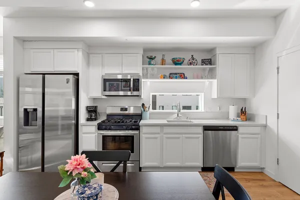 a kitchen with a sink stove and refrigerator