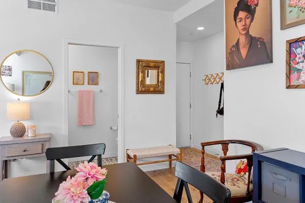 a living room with furniture and a mirror