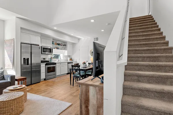 a living room with furniture and kitchen view