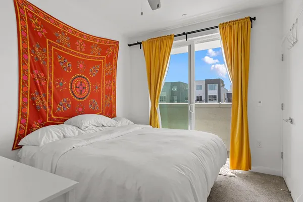 a bedroom with a bed and a window