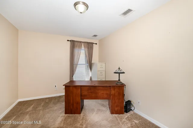 a view of staircase with a table and a potted plant
