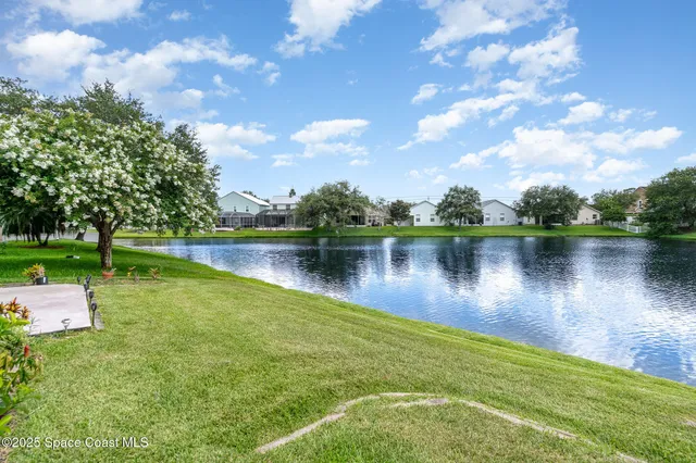 a view of a lake with houses in the back