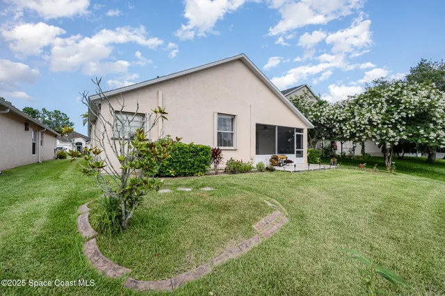 a view of a backyard with plants and a garden