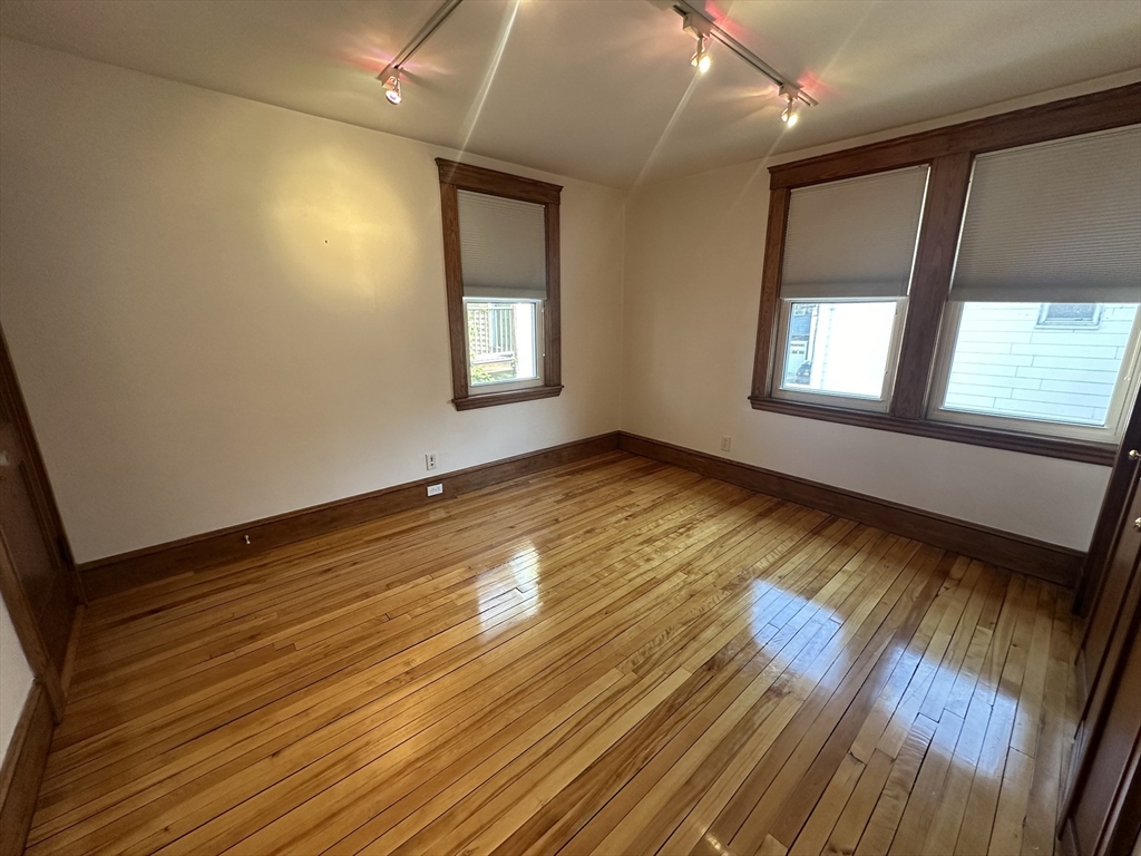 17 Herbert Road, Unit 1 Arlington, MA 02474 - Photo 15 of 26 a view of empty room with wooden floor and fan
