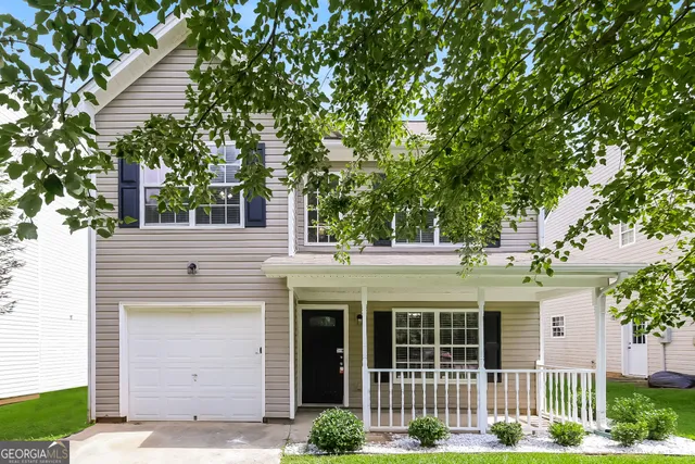 a front view of a house with garden