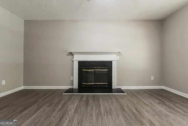 a view of an empty room and wooden floor