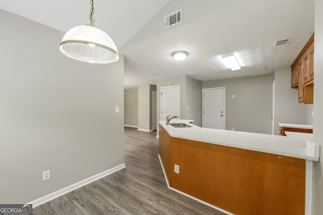 a view of room with window and wooden floor