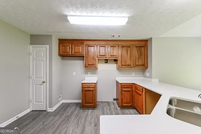 a kitchen with wooden cabinets and sink