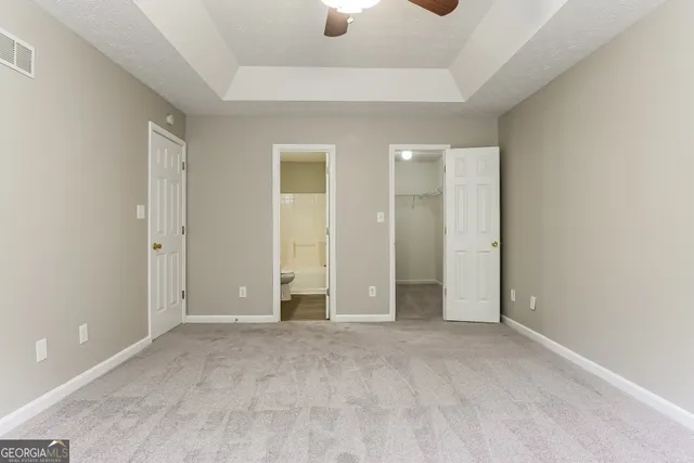 an empty room with an entryway and closet