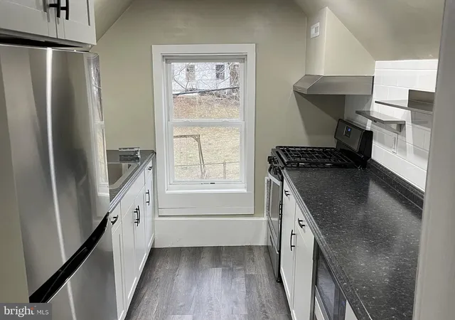a kitchen with a refrigerator and countertop