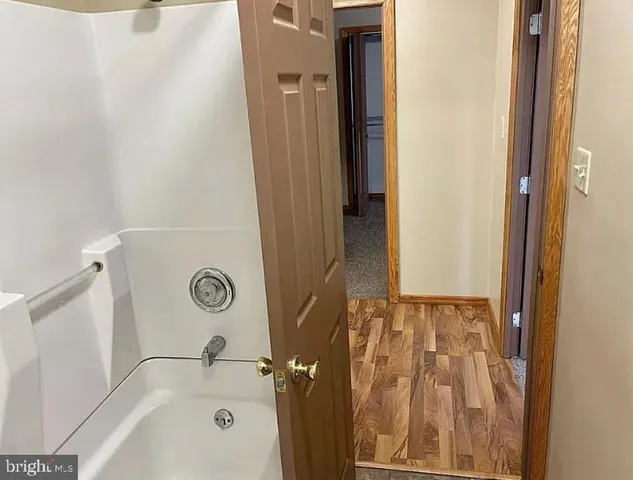 a bathroom with a bathtub and shower