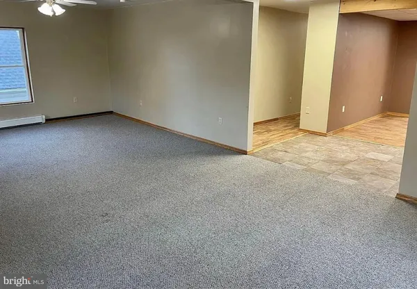 a view of room with a ceiling fan